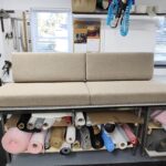 Custom-made cushions for RV featuring neutral textured fabric and professional boxed-edge tailoring on a workshop table