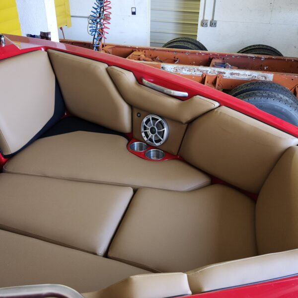 Reupholstery interior axis boat 2016 23' featuring tan and brown premium marine vinyl with red floor accents and custom speakers.