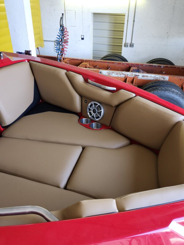 Reupholstery interior axis boat 2016 23' featuring tan and brown premium marine vinyl with red floor accents and custom speakers.