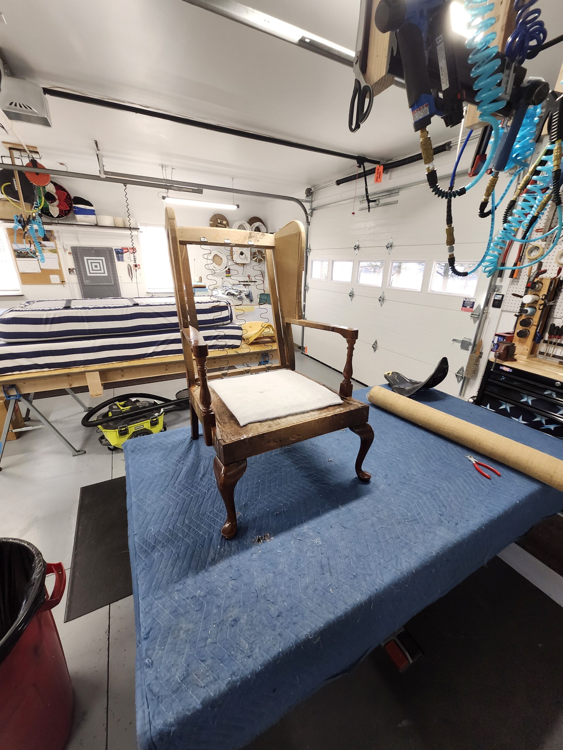Ethan Allen Queen Anne wingback chair before restoration stripped frame on workbench Alex Upholstery Shop PA