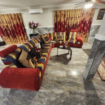 Custom curved sectional sofa in striped red blue and gold velvet
