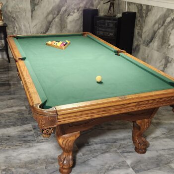 Refelted oak pool table with new green felt in Lancaster area home