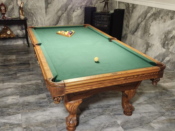 Refelted oak pool table with new green felt in Lancaster area home