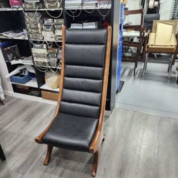 Custom high-back chair finished in channeled black leather