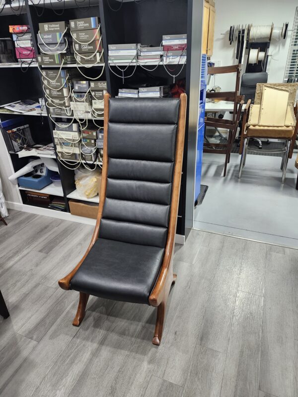 Custom high-back chair finished in channeled black leather