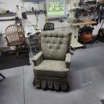 Recliner reupholstery Lebanon PA project: mid-century La-Z-Boy recliner finished in gray-green heathered tweed with a six button biscuit tufted back, padded arms, pleated skirt and turned wood posts, front view at Alex Upholstery Shop
