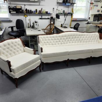 Sofa reupholstery Hershey PA project: French Provincial sofa and matching chair reupholstered in ivory textured fabric with diamond button tufted backs, welted loose cushions and refinished red-brown carved wood trim at Alex Upholstery Shop