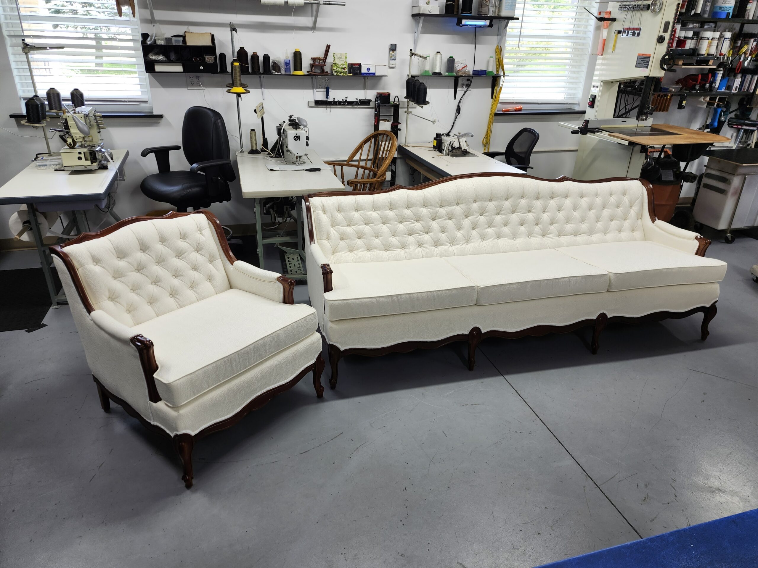 Sofa reupholstery Hershey PA project: French Provincial sofa and matching chair reupholstered in ivory textured fabric with diamond button tufted backs, welted loose cushions and refinished red-brown carved wood trim at Alex Upholstery Shop